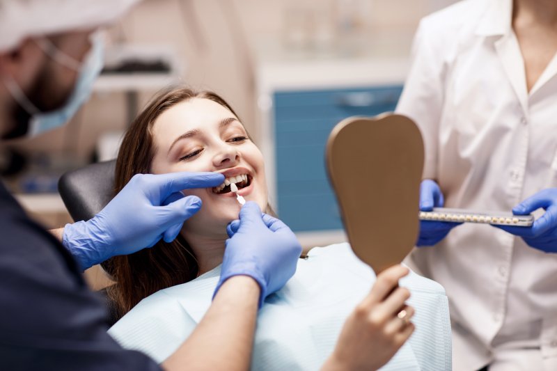 A woman getting cosmetic dentistry from her local dental team