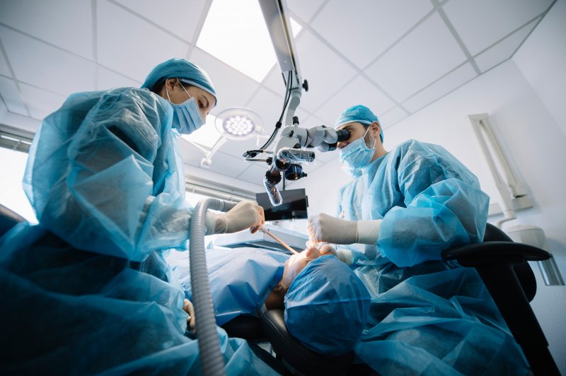 A dentist performing a dental implant surgery